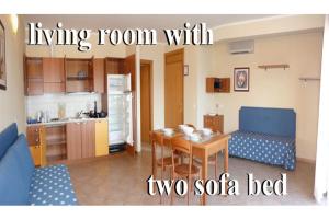 a living room with a dining room with two sofa bed at Residence Miralago Rooms & Apartments in Manerba del Garda