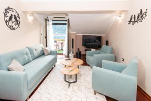 a living room with a couch and two chairs and a table at Apartment Ena with amazing sea view in Kotor