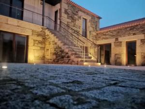 an empty courtyard of a stone building with stairs at Casa de Trás-o-Muro in Vila Real