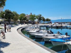 a group of boats docked in a harbor at Apartment Sol Dolcevita in Njivice