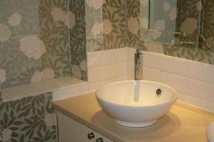 a bathroom with a white sink on a counter at Beansheaf Hotel in Pickering