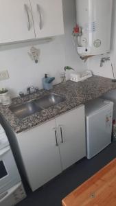 a kitchen with a sink and a counter top at Mar de Anto in Puerto Madryn