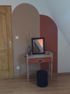 a room with a table with a mirror on it at Chambre d'hôtes chez CBL déco in Saint-Germain-des-Essourts