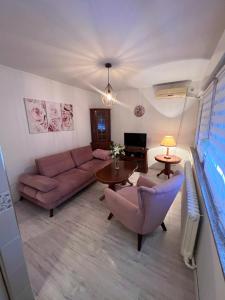 a living room with a couch and a table at Apartman Krasota in Banja Luka