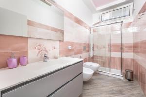 a bathroom with a toilet and a sink and a shower at Partenope in Sorrento Coast in Piano di Sorrento