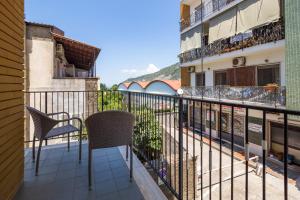 a balcony with two chairs and a building at Partenope in Sorrento Coast in Piano di Sorrento +8 photos