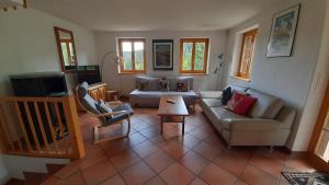 a living room with a couch and a table at Acla Pala in Lenzerheide