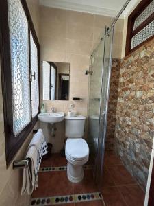 a bathroom with a toilet and a sink and a shower at Casa Medina Sanaa Tetouan in Tétouan