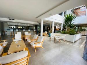 a restaurant with white chairs and tables and chairs at Choisy Les Bains D2 in Mont Choisy