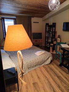 a bedroom with a bed with a lamp on it at Il Piccolo Tibet - Gran Sasso in LʼAquila