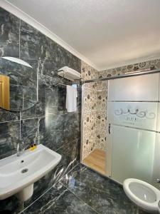 a bathroom with a sink and a shower at Parfe Apart in Trabzon