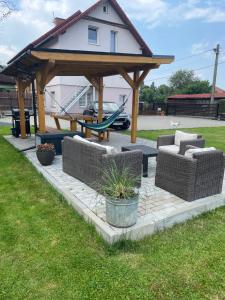 a gazebo with couches and a picnic table at Apartament MONABERG in Łomnica