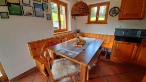 a dining room with a wooden table and chairs at Acla Pala in Lenzerheide