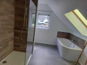 a bathroom with a shower and a bath tub at Gite Comme chez soi in Spa