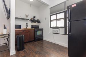a kitchen with a black refrigerator and a window at Miami Downtown Cozy Studio near to South Beach - 5 minutes to Wynwood in Miami
