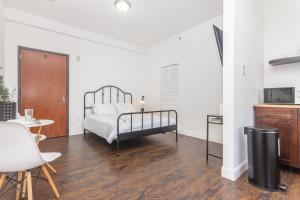 a bedroom with a bed and a table and a kitchen at Miami Downtown Cozy Studio near to South Beach - 5 minutes to Wynwood in Miami