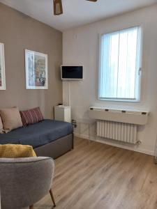 a living room with a bed and a window at Apartment Cafoscari in Venice