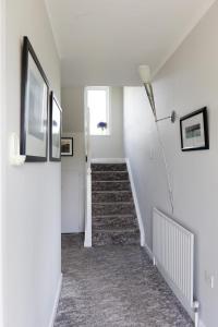 a hallway with a stairway with a stair case at Lios Na Manach ECO B&B in Killarney
