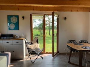 een keuken en eetkamer met een tafel en stoelen bij Domek wypoczynkowy Sosenkowo in Suwałki