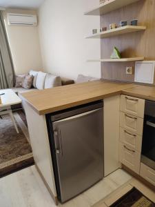 a kitchen with a counter with a dishwasher at Кай Apartment's Sarafovo in Burgas City