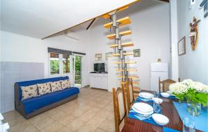 a living room with a blue couch and a table at Lovely Home In Duga Resa With Outdoor Swimming Pool in Duga Resa