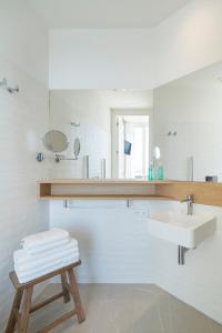 a white bathroom with a sink and a mirror at Porto Real Hotel in Finisterre