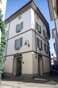 a large white building with a door and windows at Hotel Centrale Best Western Signature Collection in Tirano