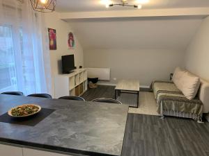 a living room with a table and a couch at Coquet appartement aux pieds des montagnes in Scionzier