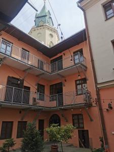 a building with a clock tower in the background at Town Square Apartment in Lublin +5 photos