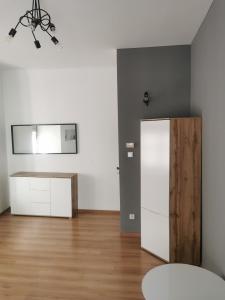 a room with a white cabinet and a mirror at Town Square Apartment in Lublin