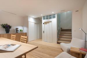 a living room with a table and a stairway at Porto Real Hotel in Finisterre