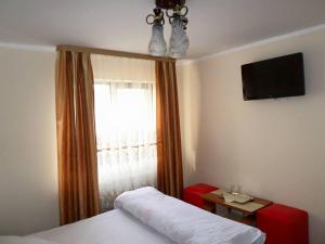 En eller flere senge i et værelse på Casa Montana Busteni