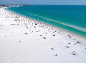 a group of people on a beach near the ocean at Beach Downtown Pet-friendly 1 BD @ The Park-633 in Sarasota