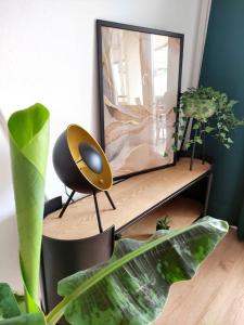 a desk with a mirror and a chair and some plants at Sauna, Pools und XXL-Terasse in Sankt Englmar