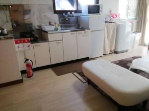 eine Küche mit weißen Schränken und einem Waschbecken in der Unterkunft Corpo Marika 0 - Vacation STAY 81260v in Hakodate