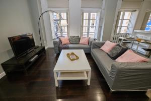 ein Wohnzimmer mit 2 Sofas und einem TV in der Unterkunft Galera51 by Serendipia Turismo in A Coruña