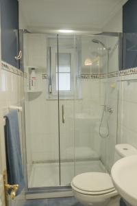 a bathroom with a shower with a toilet and a sink at Bellamar Playa Santa Maria in Naveces