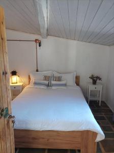 a bedroom with a large white bed in a room at Κυμοθόη in Milopotamos