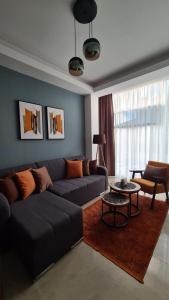 a living room with a couch and a table at Apartman Orange in Bugojno