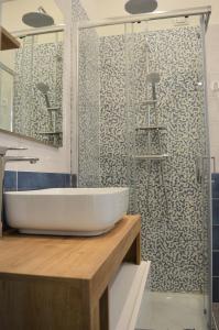 a bathroom with a white sink and a shower at La Puteca in Naples