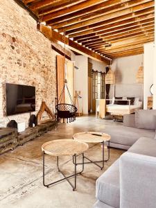 a living room with two tables and a fireplace at Casa Doggio, Loft con historia in Cartagena