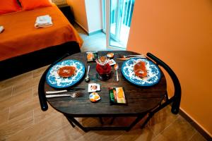 a table with two plates of food on it at IRTO B&B in Castellammare di Stabia
