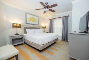 ein Schlafzimmer mit einem Bett und einem Flachbildfernseher in der Unterkunft WorldMark Orlando Kingstown Reef in Orlando