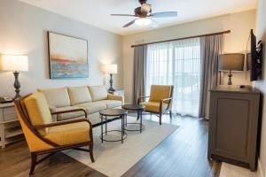 a living room with a couch and chairs and a table at WorldMark Orlando Kingstown Reef in Orlando