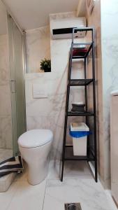 a bathroom with a toilet and a ladder in it at Think Home, exploring the center of Thessaloniki in Thessaloniki