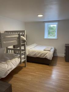 a bedroom with two bunk beds and a window at Peacock Farm Estate Self Contained Lodges in Cork