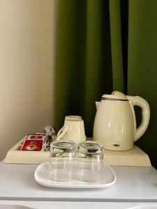 a counter with a tea kettle and glasses on it at Casa Del Sole B&B in Tropea