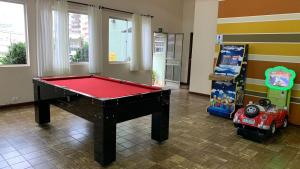 a room with a pool table and a video game at Foz Presidente Economic Hotel in Foz do Iguaçu
