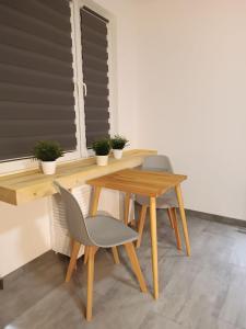 a wooden table with two chairs and a table and a table and a table at Apartament Bukowy in Zakopane