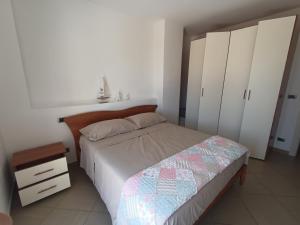 a bedroom with a bed and white wardrobes at Atlantic Roseto sul mare in Roseto degli Abruzzi